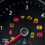 An dashboard with several icons lit up including the check engine light