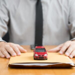 Toy car sitting atop a pile of Chevy financing documents