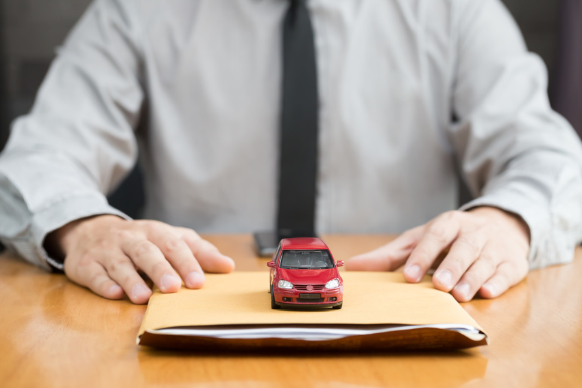 Toy car sitting atop a pile of Chevy financing documents