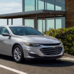 A used Chevy vehicle parked in front of a house