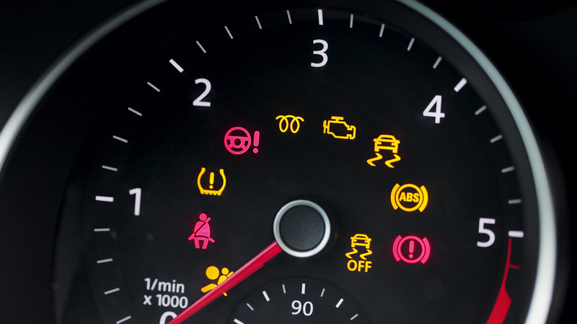 An dashboard with several icons lit up including the check engine light