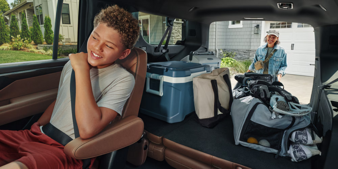 Woman loading the cargo area of the 2026 Chevrolet Suburban