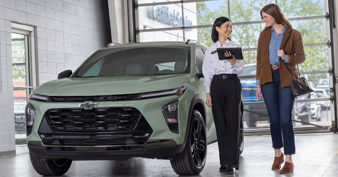 Customer speaking with salesperson at a Chevrolet dealership